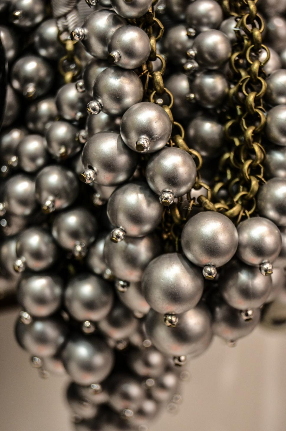 Free Image of Multiple Silver Balls Hanging From a Chain 