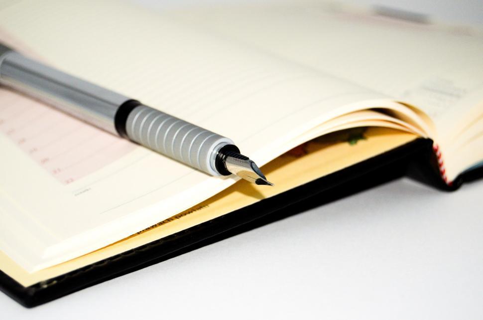 Free Image of Open Notebook With Pen 