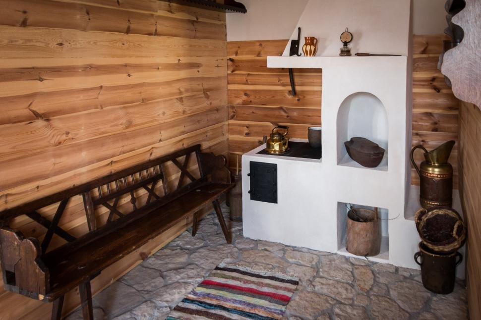 Free Image of Wooden Room With Stove and Bench 