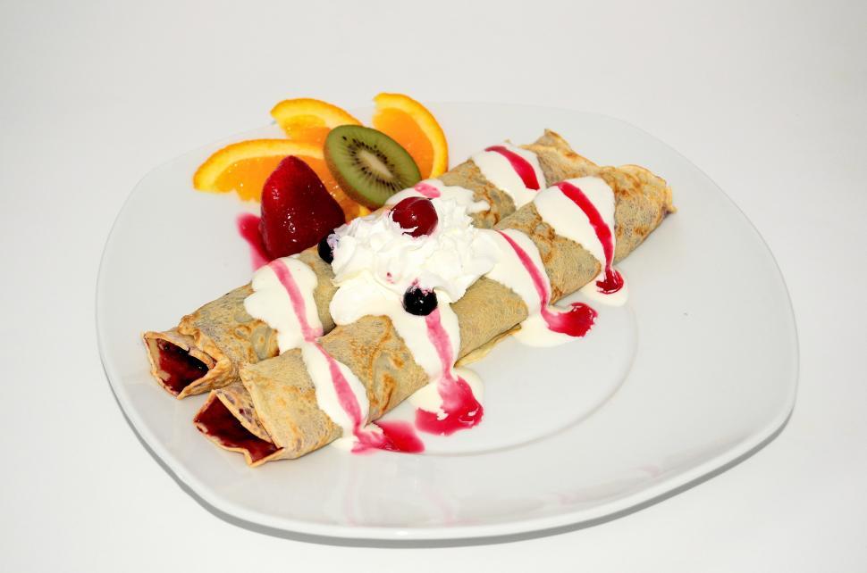 Free Image of White Plate With Fruit-Topped Crepe 