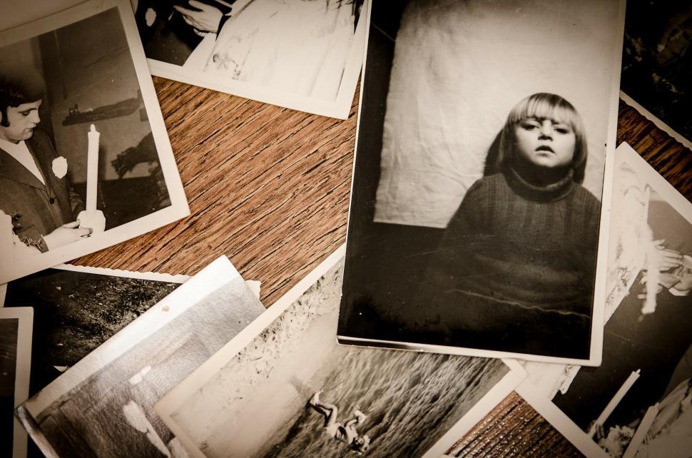 Free Image of Pile of Black and White Photos on a Table 