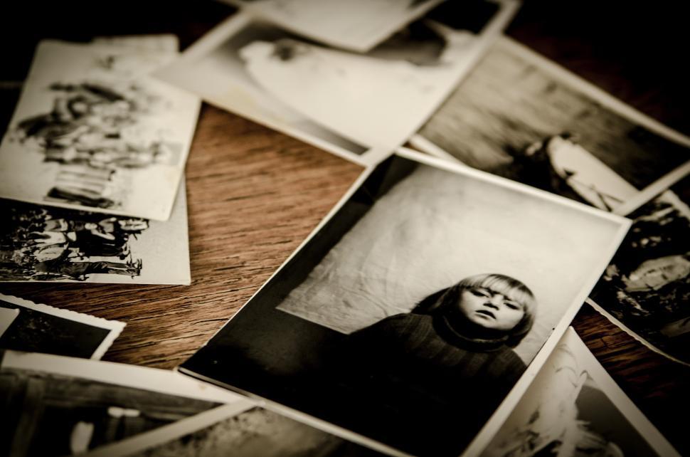 Free Image of Table With Black and White Pictures of People 