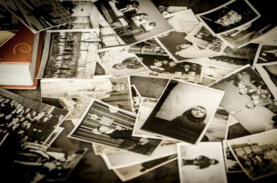 Free Image of Stack of Black and White Photos on Table 