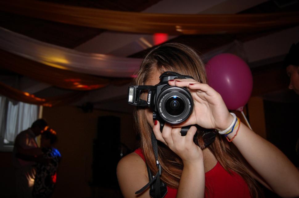 Free Image of Woman Taking a Picture With a Camera 