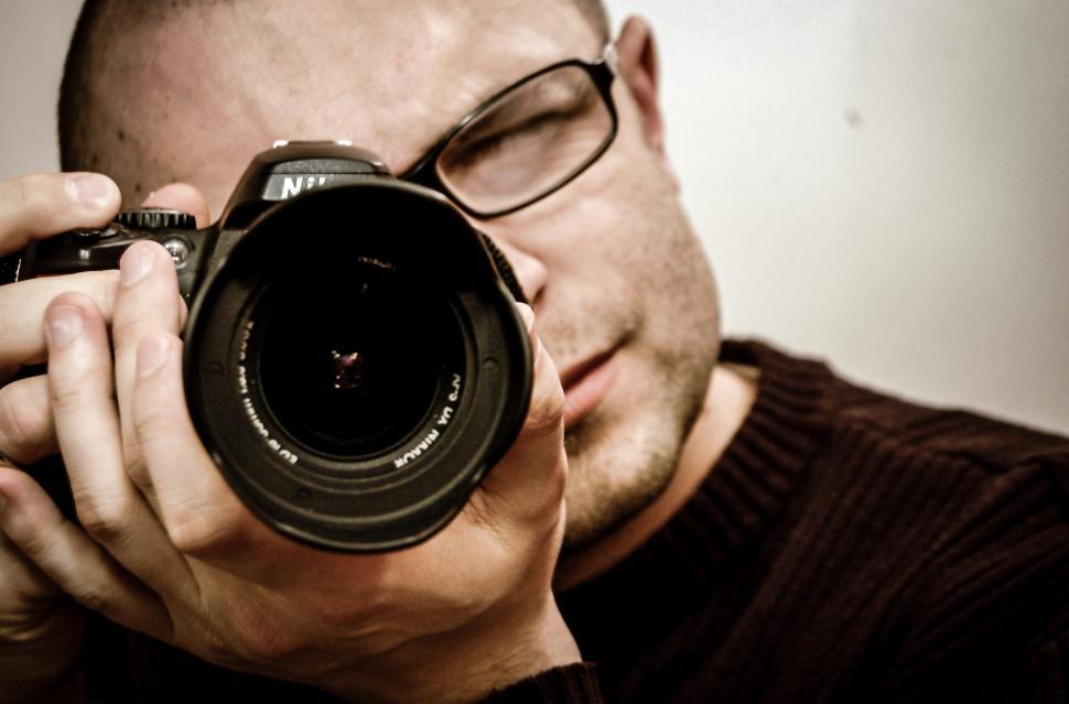 Free Image of Man Holding Camera to His Face 