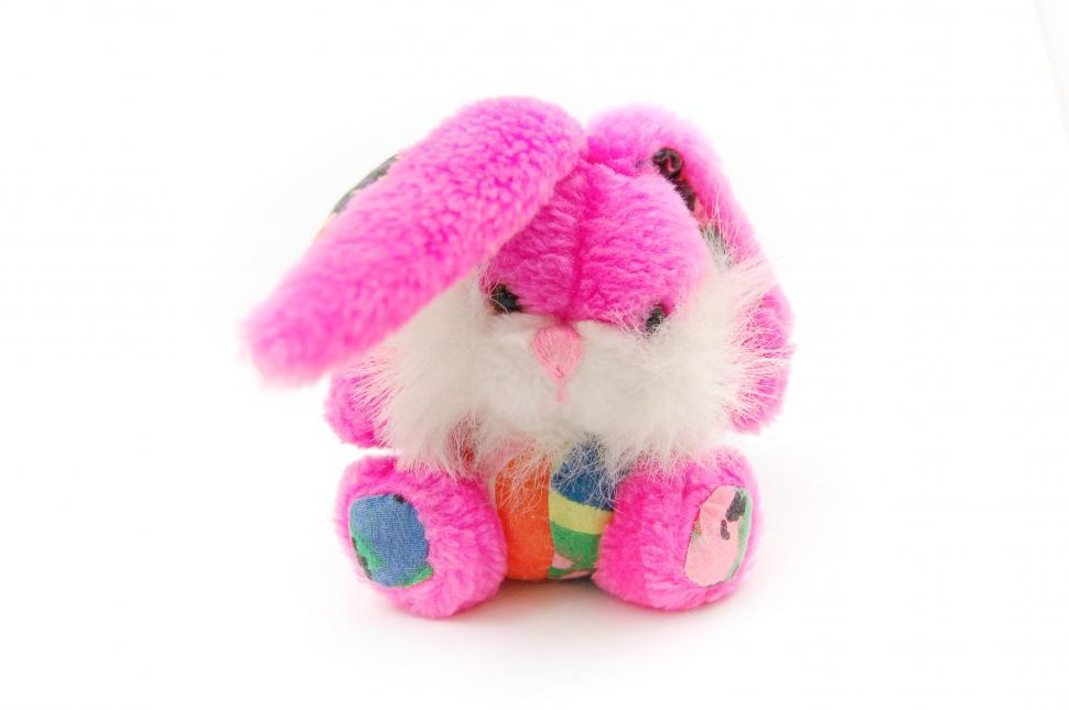Free Image of Pink Stuffed Animal Resting on White Surface 