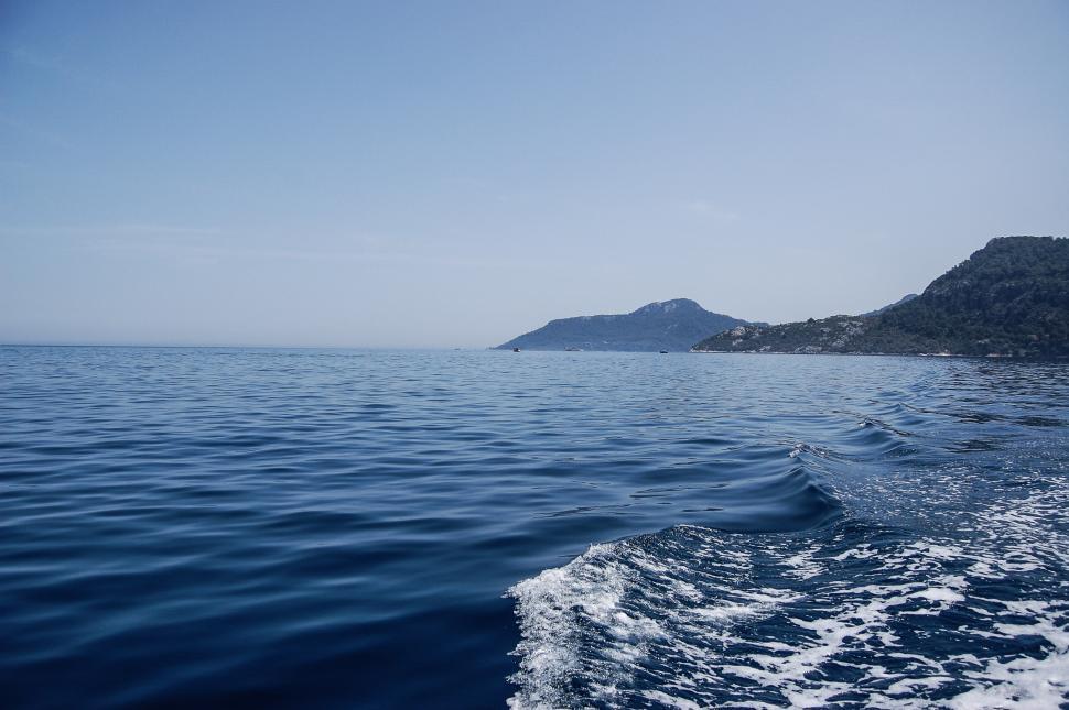Free Image of Body of Water With Small Island in the Distance 