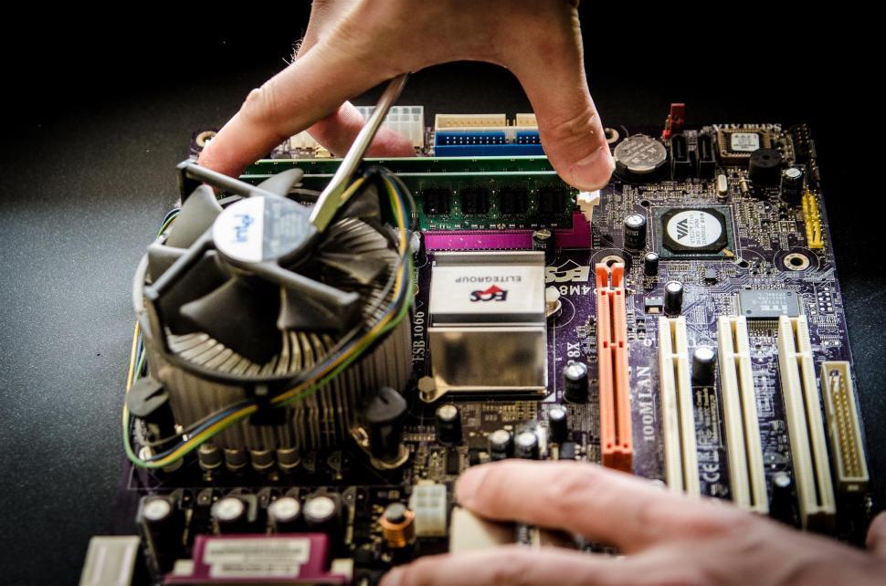 Free Image of Person Working on Computer Motherboard 
