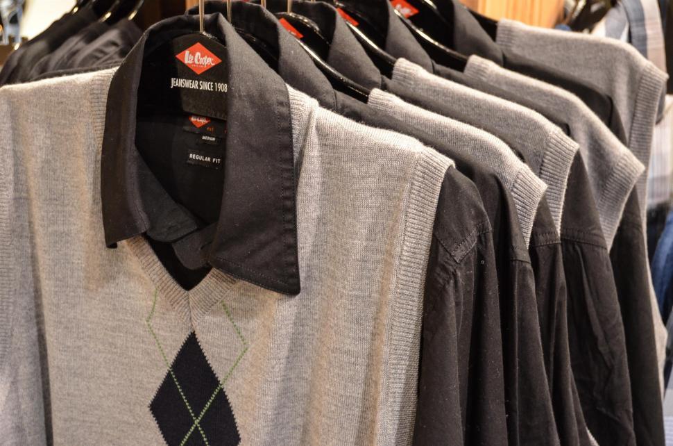 Free Image of Row of Shirts Hanging on Rack in Store 