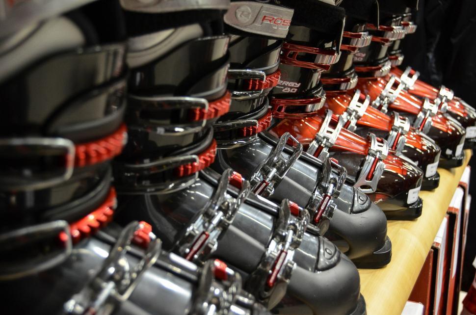 Free Image of Many Pairs of Ski Boots Lined Up on a Table 