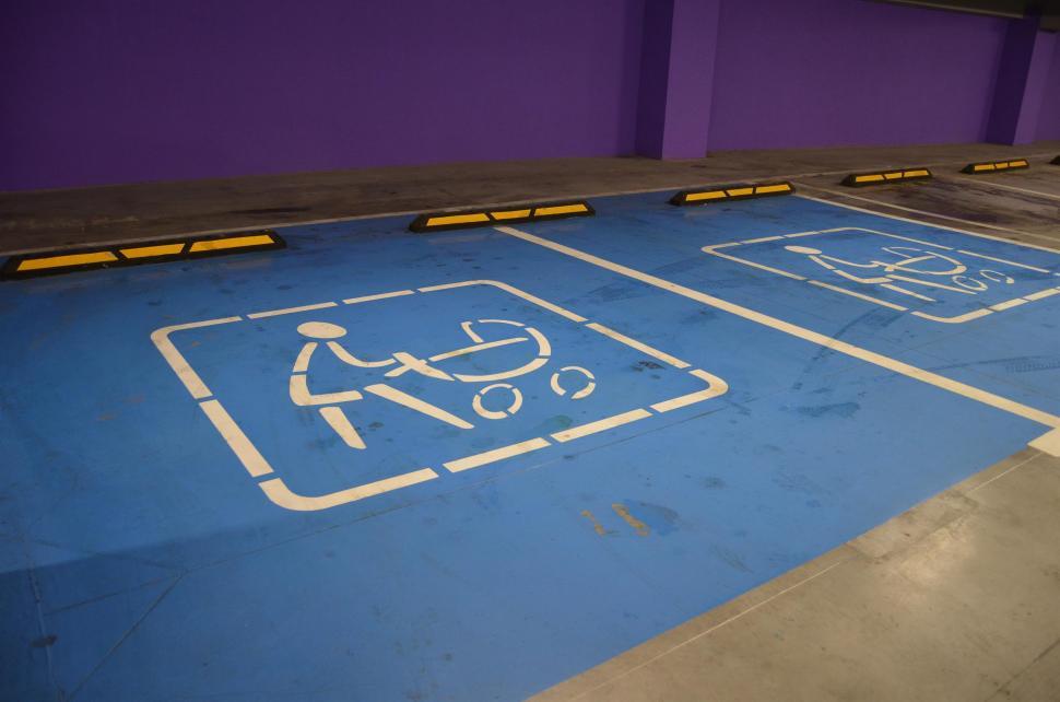 Free Image of Blue Parking Lot With Handicap Sign 