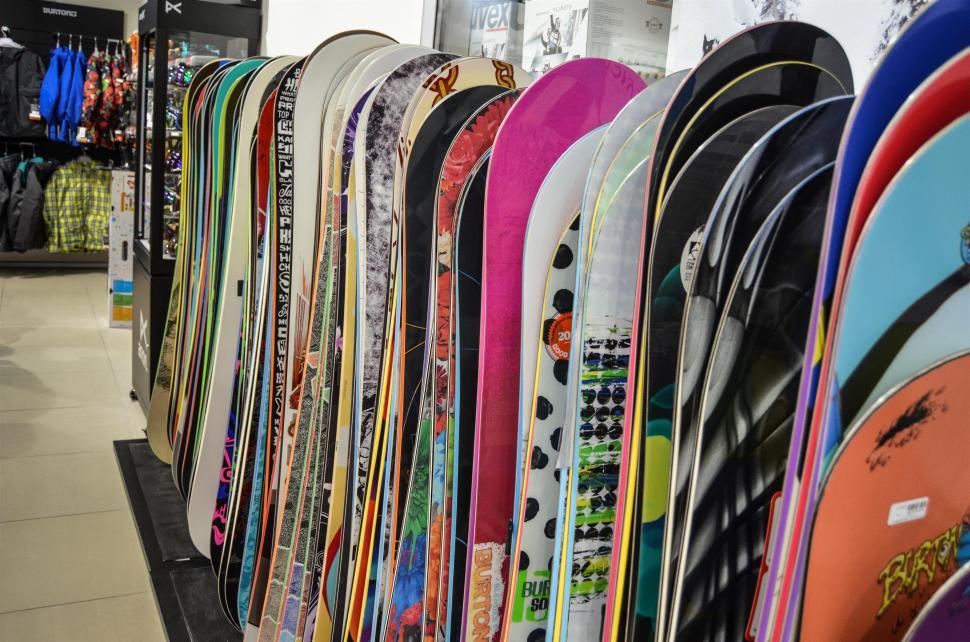Free Image of Assorted Rack of Skis and Snowboards in Store 