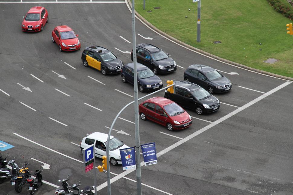 Free Image of Group of Cars Driving Down Street Next to Traffic Light 