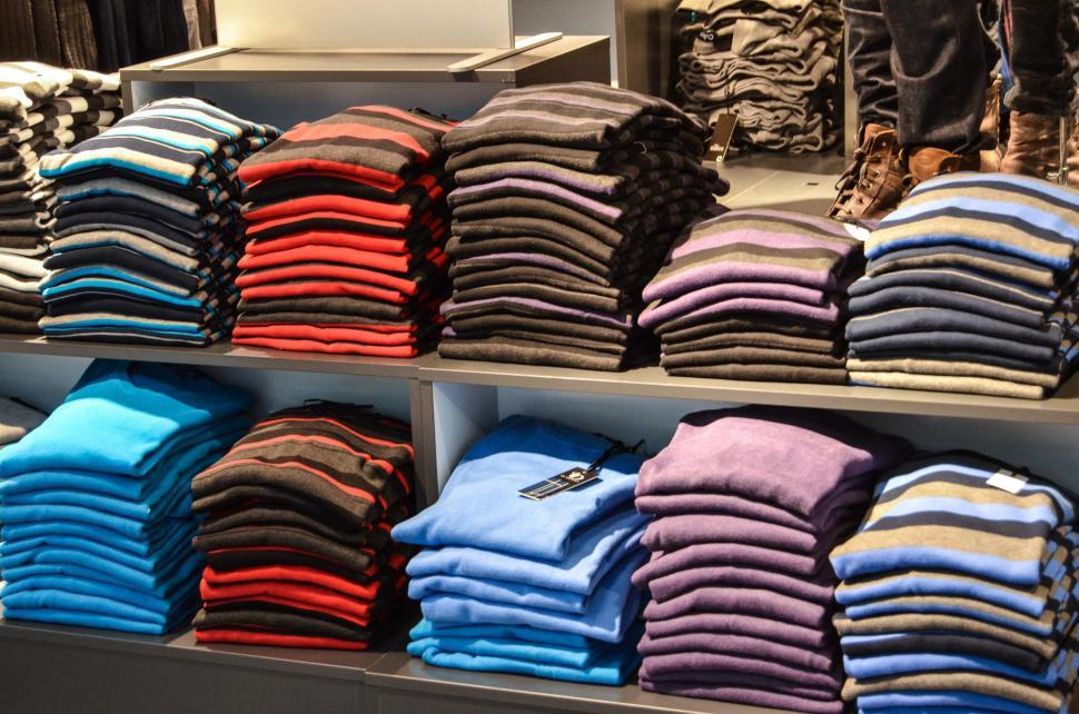 Free Image of Display Case Filled With Different Colored Shirts 
