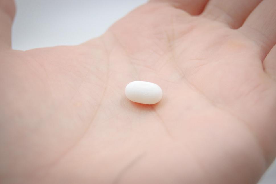 Free Image of White Pill Resting on Persons Stomach 
