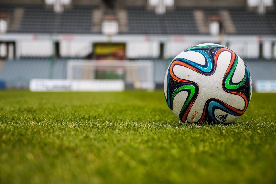 Free Image of Soccer Ball Resting on Lush Green Field 