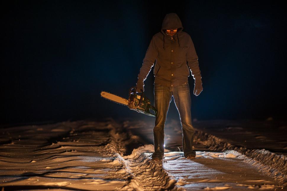 Free Image of Man Holding Snowboard in the Dark 
