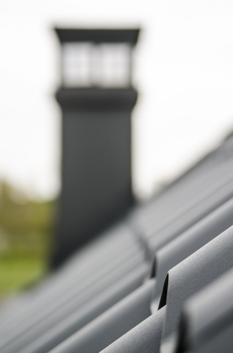 Free Image of Metal Roof Close Up With Clock Tower in Background 
