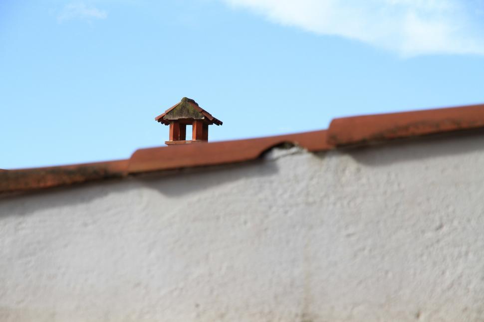 Free Image of Bird Perched on Roof of Building 