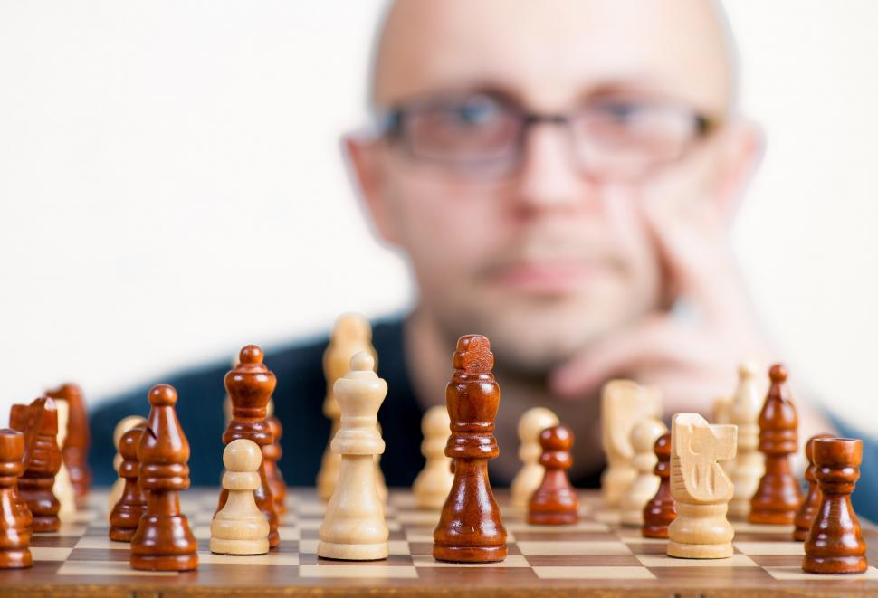 Free Image of Man Examining Chess Board 