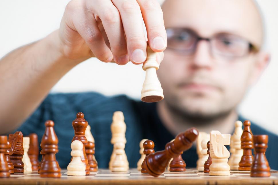 Free Image of Man Engaged in Chess Game 