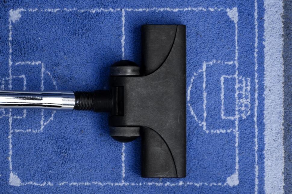 Free Image of Blue Rug With Black Handle 