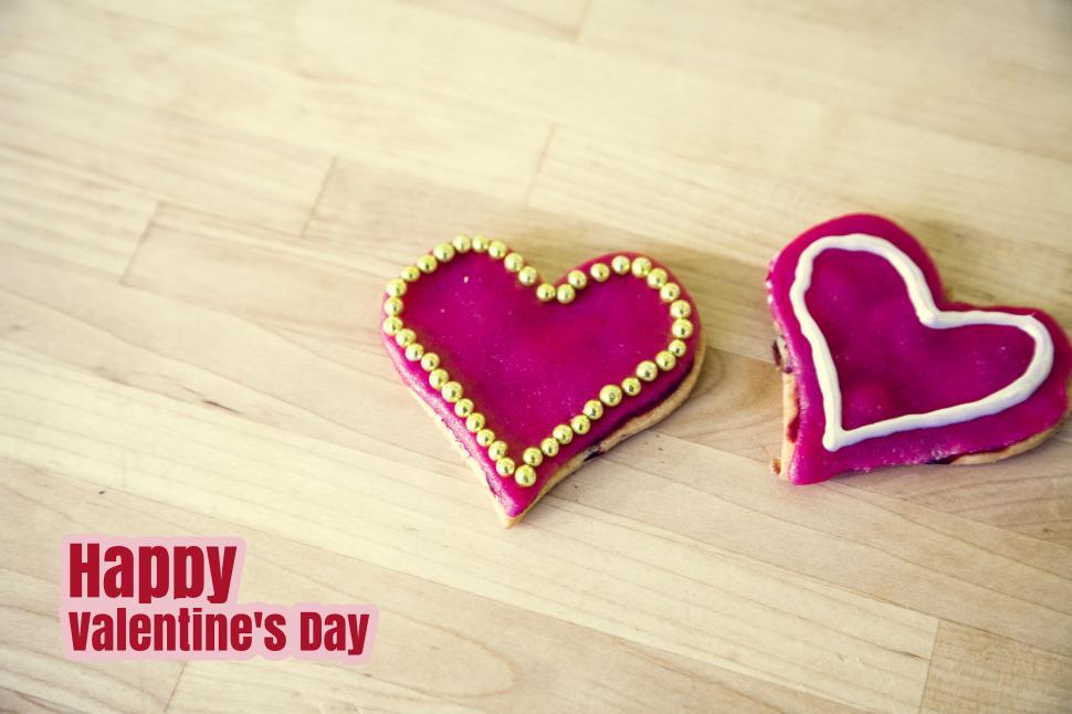 Free Image of Two Heart Shaped Cookies on Wooden Table 