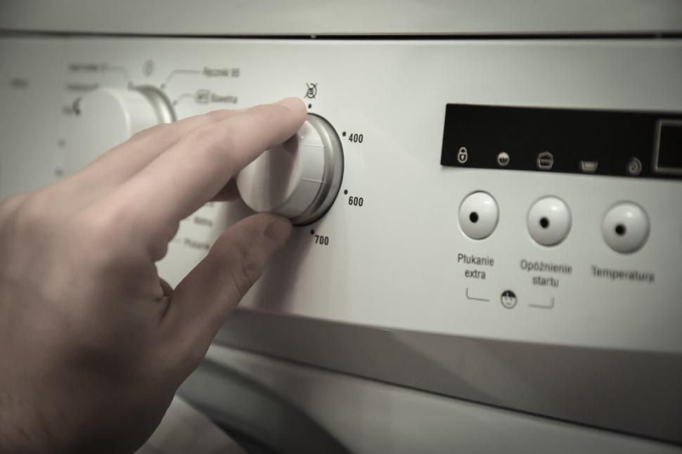 Free Image of Person Pressing Buttons on Washing Machine 