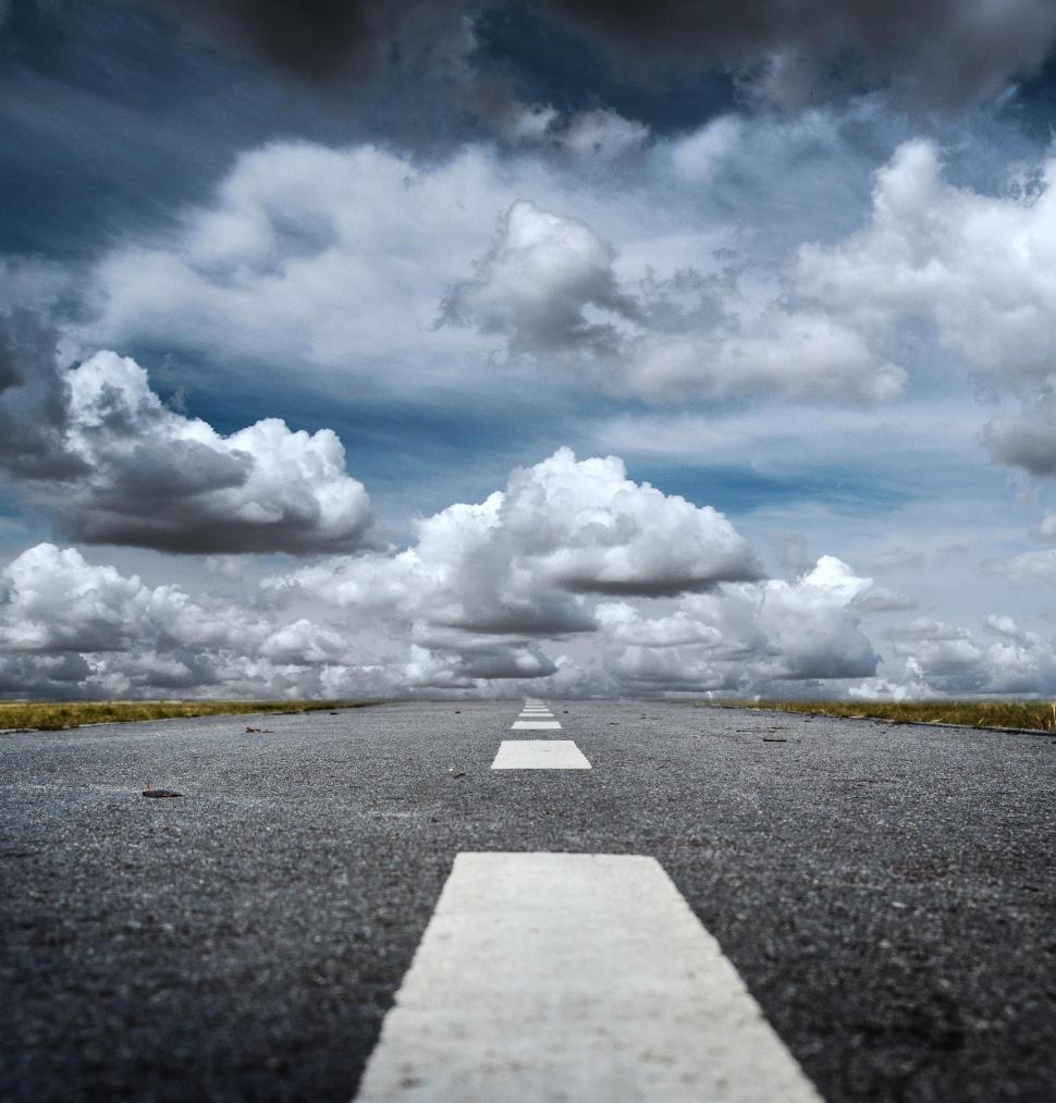 Free Image of Deserted Road Under Cloudy Sky 