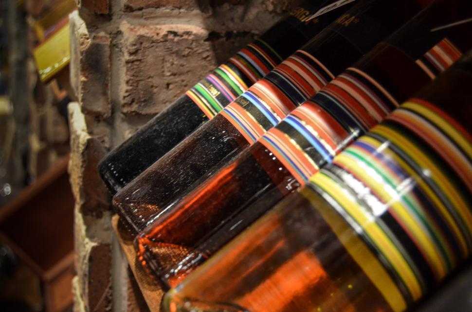 Free Image of Colored Ribbons Hanging on Brick Wall 
