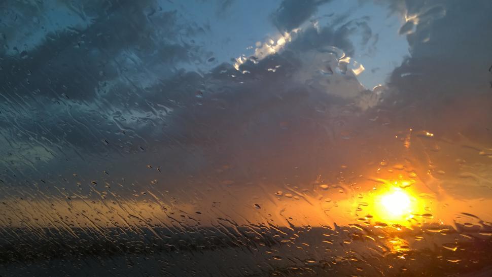 Free Image of Rain on a window at sunset  