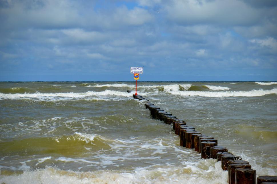 Free Image of Breakwaters with a wooden deck in a stormy sea. Baltic Sea  