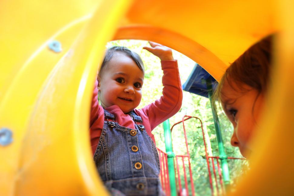 Free Image of Babies Playing On the Slide 