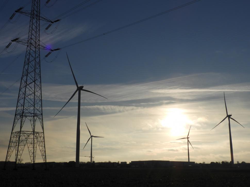 Free Image of Four wind turbines and a power line mast  