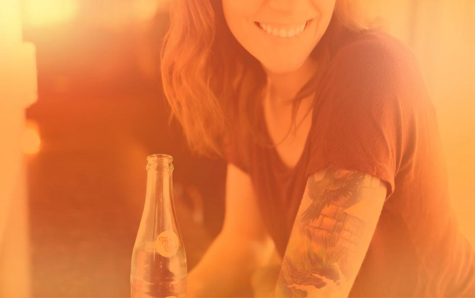 Free Image of Woman with Drink Smiling - Colorized Hazy Effect 