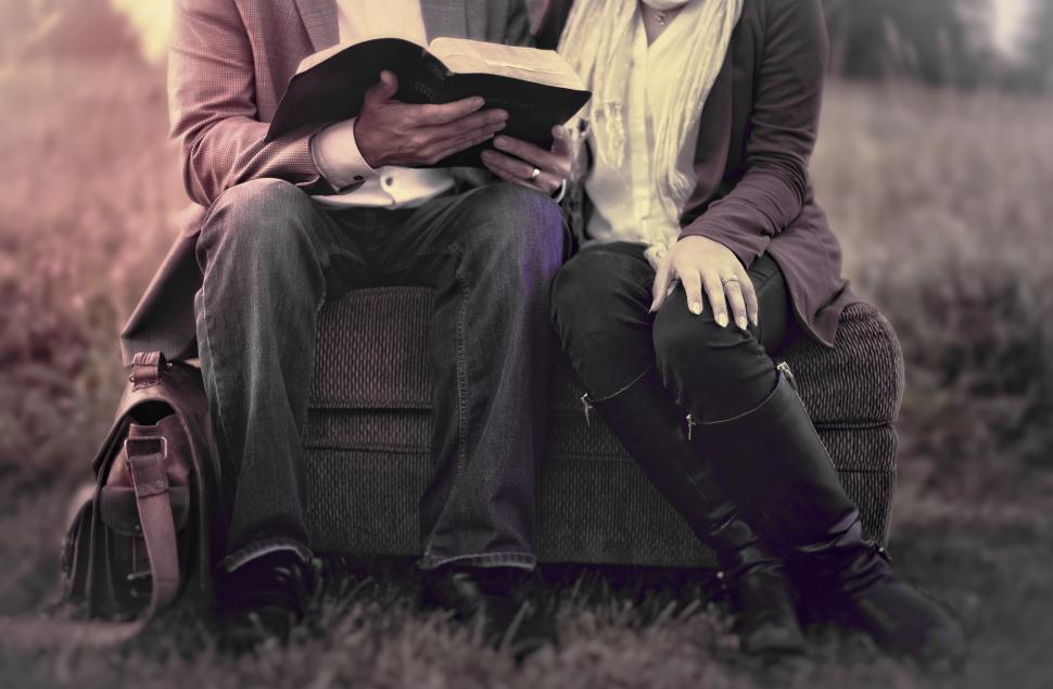 Free Image of Couple in Love Reading Outdoors - Washed-out Effect 