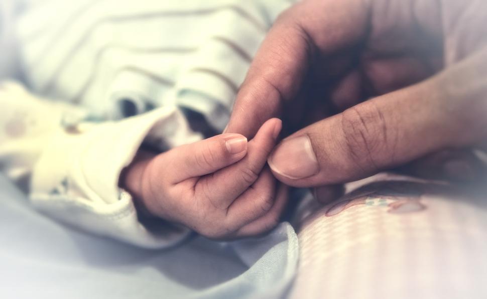 Free Image of Father Touching Hand of Newborn Baby 