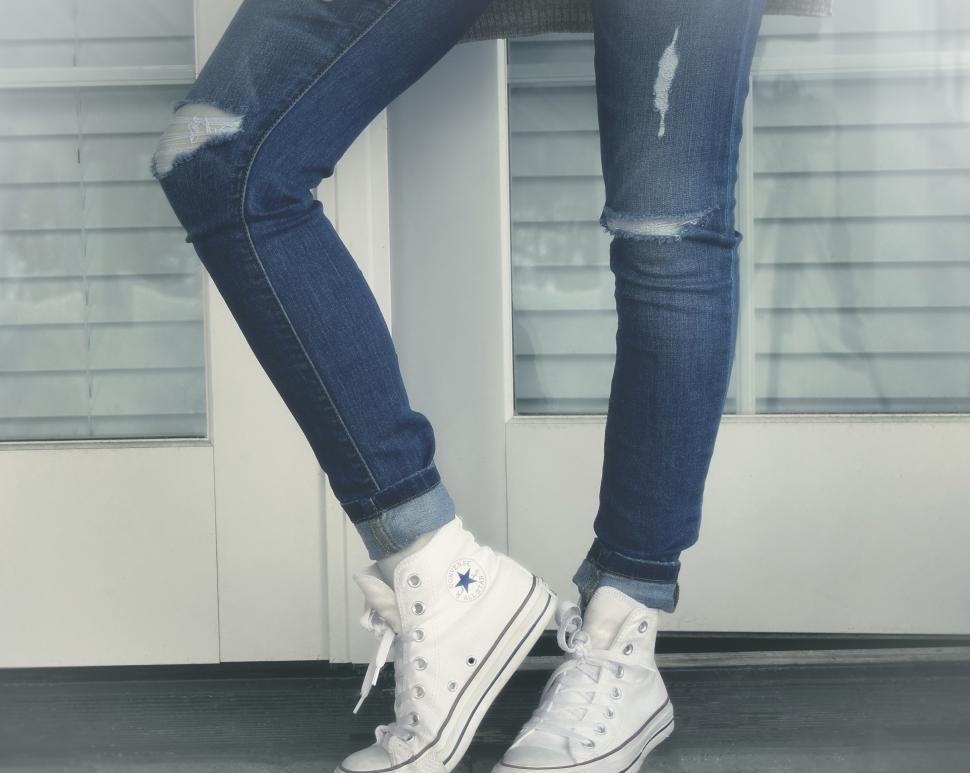 Free Image of Urban Girl - Close-Up of Legs - Ripped Jeans and Sneakers 