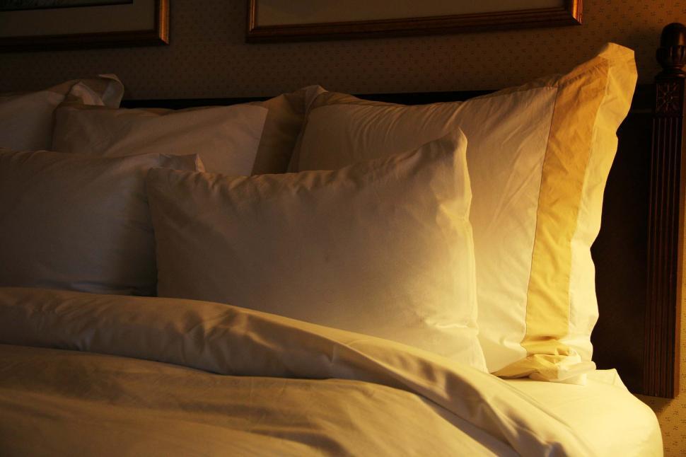 Free Image of Close Up of Bed With White Sheets and Pillows 