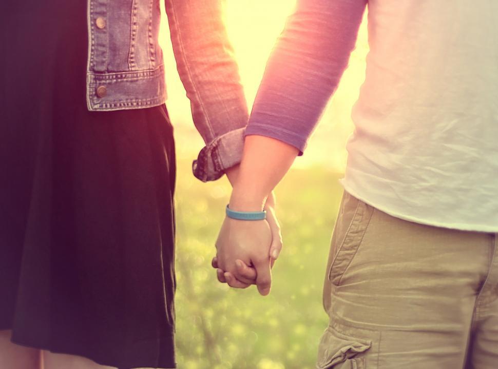 Free Image of Couple Walking Hand in Hand 
