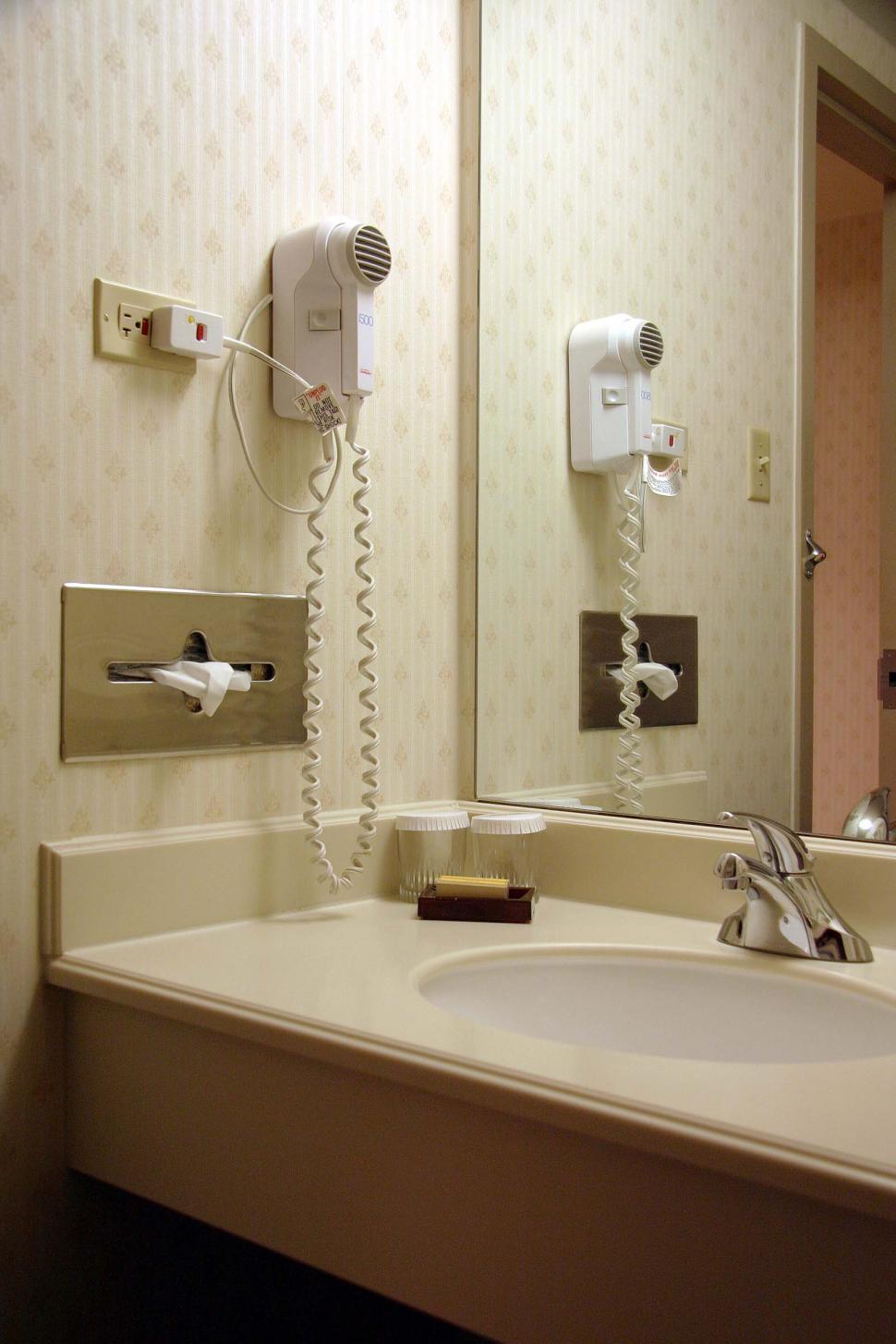 Free Image of Bathroom Sink With Wall-Mounted Phone 