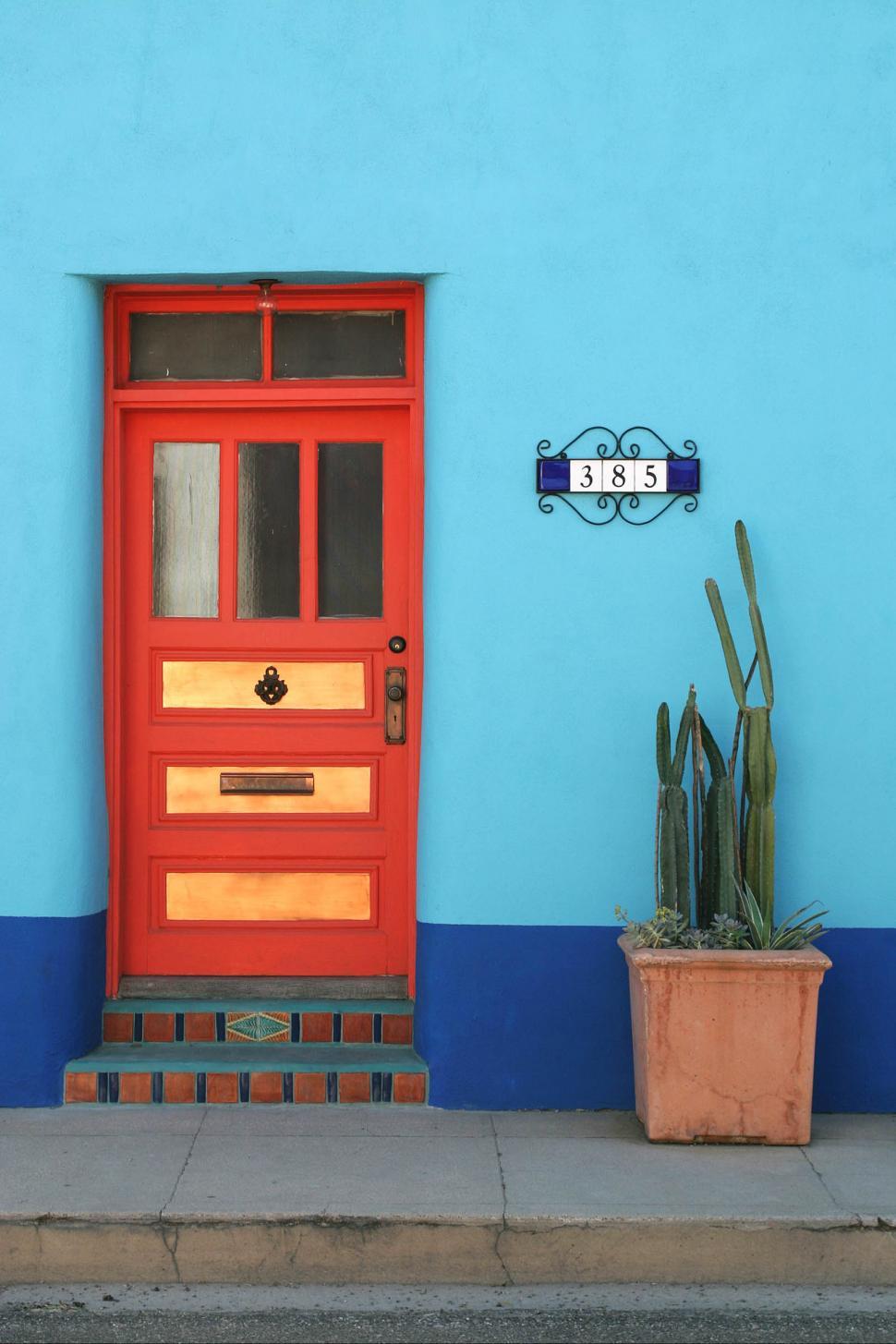 Free Image of Red Door Against Blue Wall With Plant 