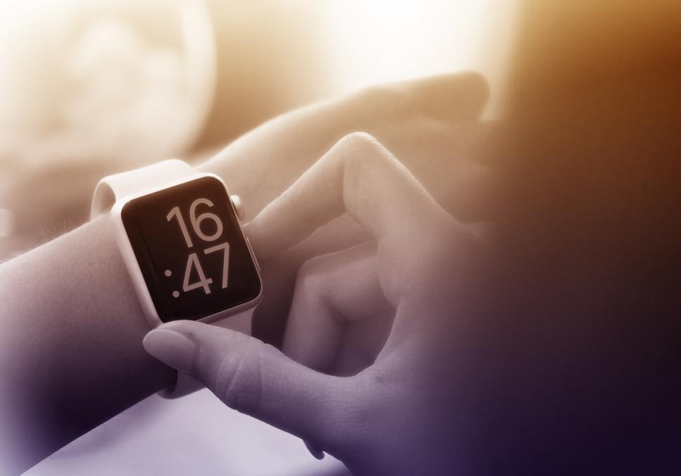 Free Image of Time to Go - A Woman Checks the Time on Smartwatch 