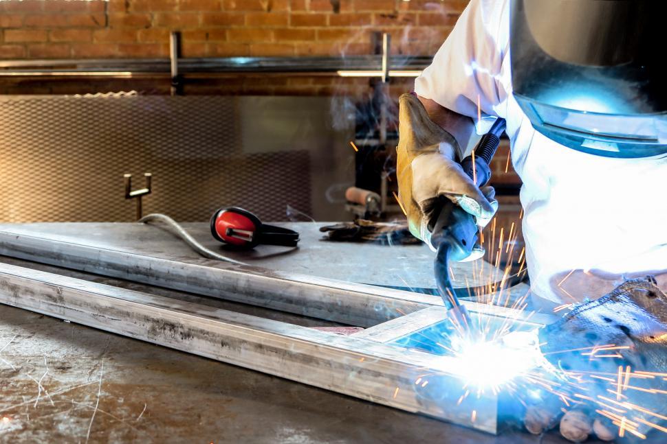 Download Free Stock Photo of Welding a metal truss 