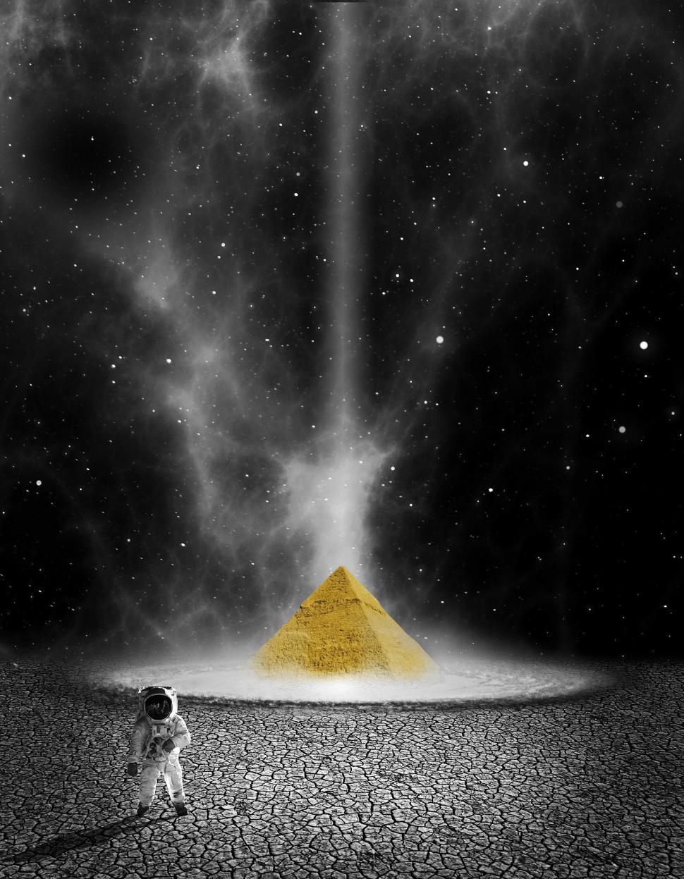 Free Image of Astronaut Standing in Front of Yellow Pyramid 