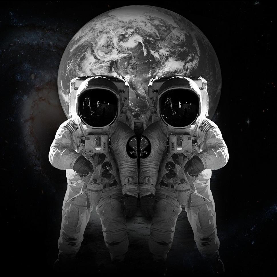Free Image of Astronaut Standing Next to Earth Globe 