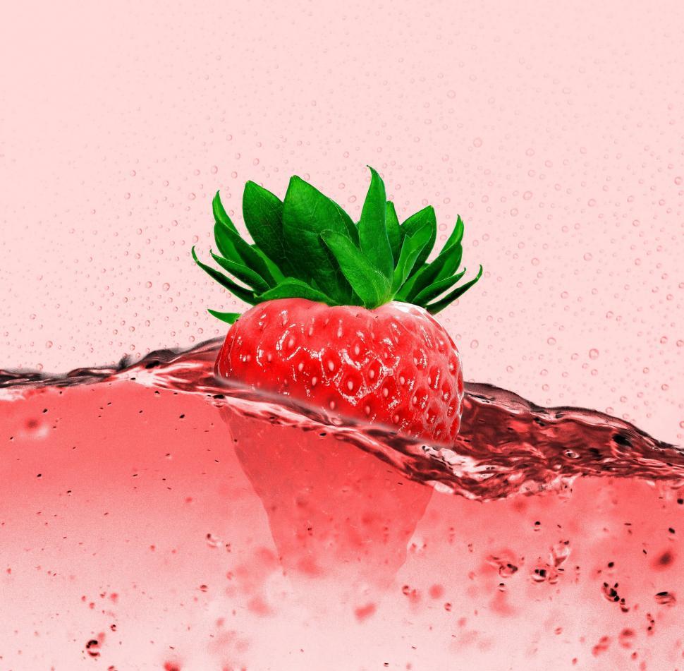 Free Image of Strawberry Floating on Pink Liquid 