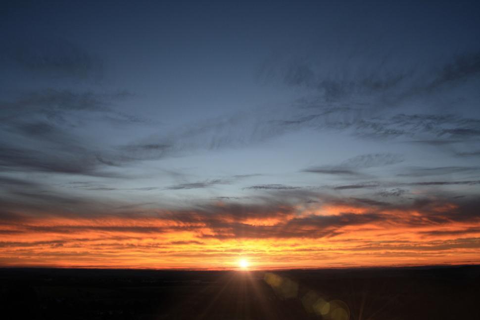 Free Image of The Sun Setting Over the Horizon of a Field 