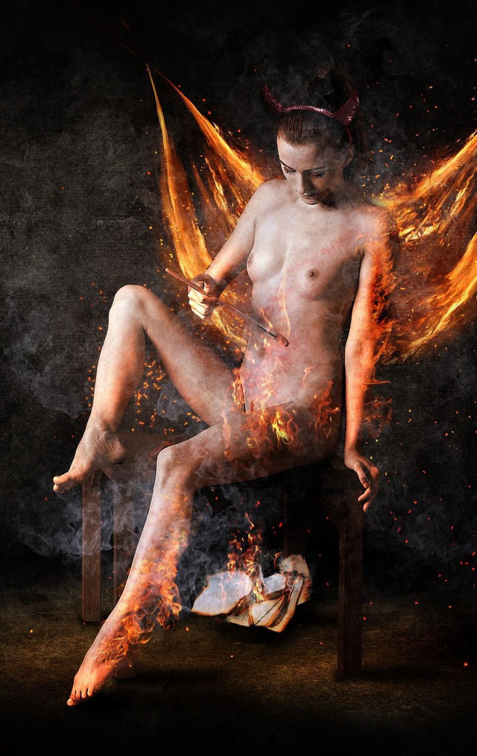 Free Image of Naked Woman Sitting on Chair Covered in Fire 