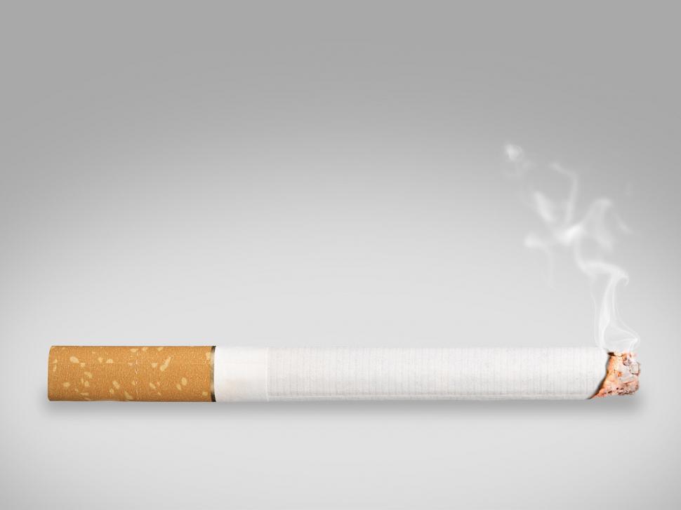 Free Image of Smoking Cigarette With Rising Smoke 
